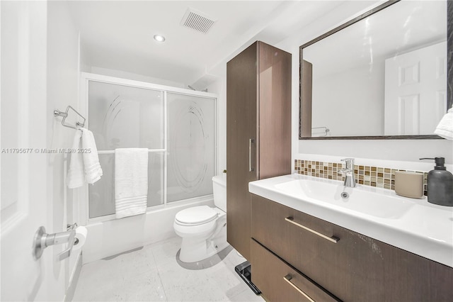 full bath featuring visible vents, tasteful backsplash, vanity, combined bath / shower with glass door, and toilet