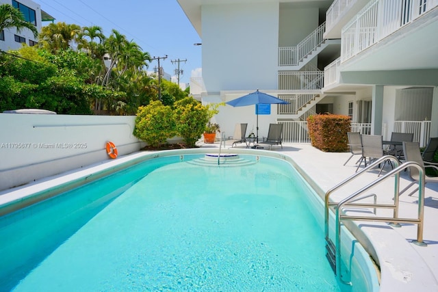 view of pool featuring a fenced in pool, fence, and a patio