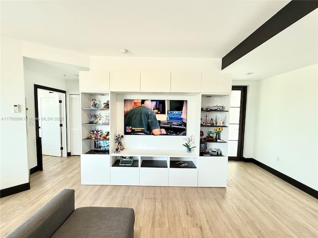 living area with baseboards and light wood finished floors