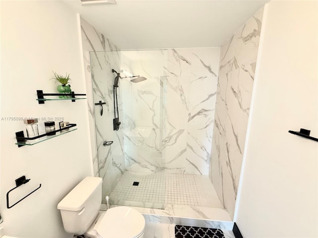 bathroom featuring toilet, visible vents, and a marble finish shower
