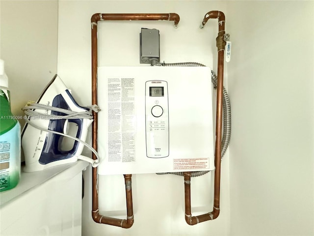 utility room featuring water heater