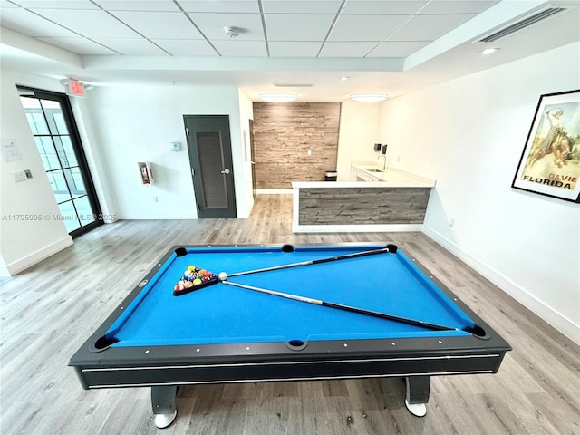 game room with wood finished floors, baseboards, a paneled ceiling, and visible vents