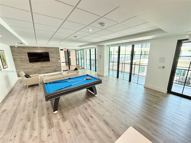 game room featuring baseboards, light wood finished floors, pool table, and a paneled ceiling