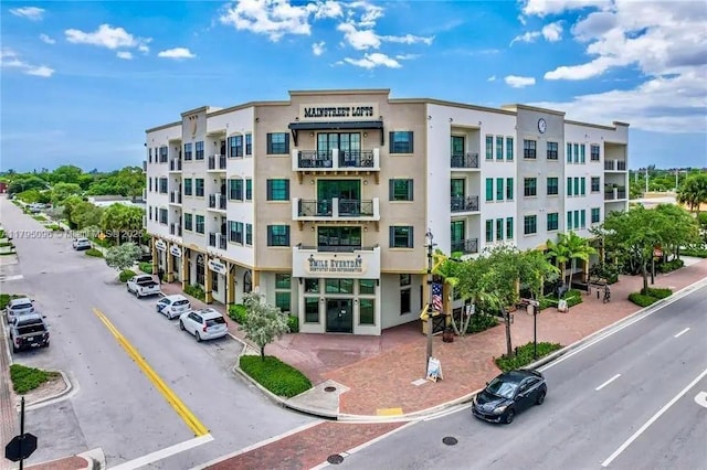 view of property featuring uncovered parking