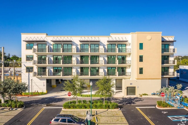 view of building exterior featuring uncovered parking