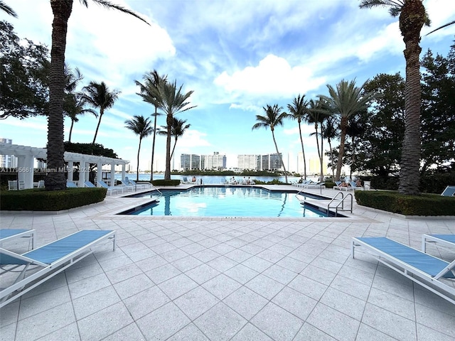 pool featuring a pergola and a patio area