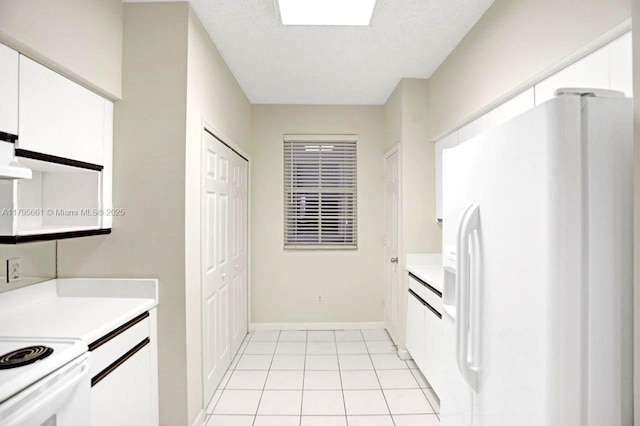 kitchen with white cabinetry, light countertops, baseboards, white appliances, and light tile patterned flooring