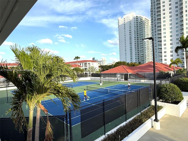 view of sport court featuring fence