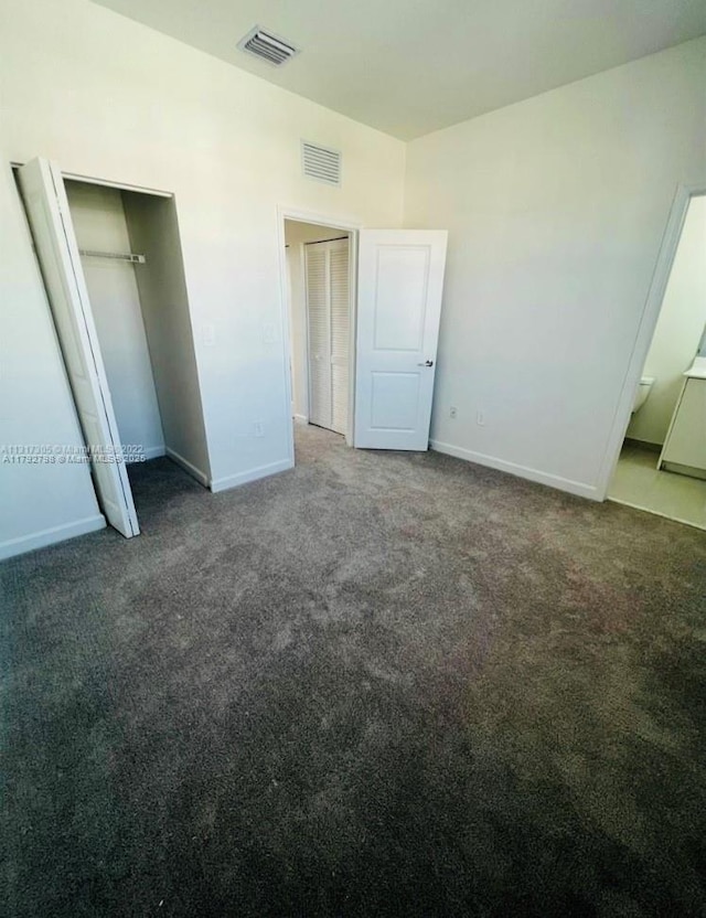unfurnished bedroom featuring carpet flooring, baseboards, and visible vents