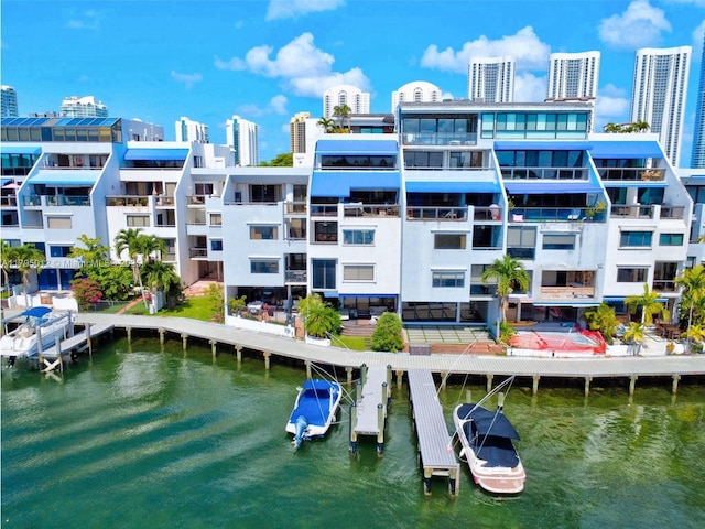 view of building exterior featuring a water view and a city view