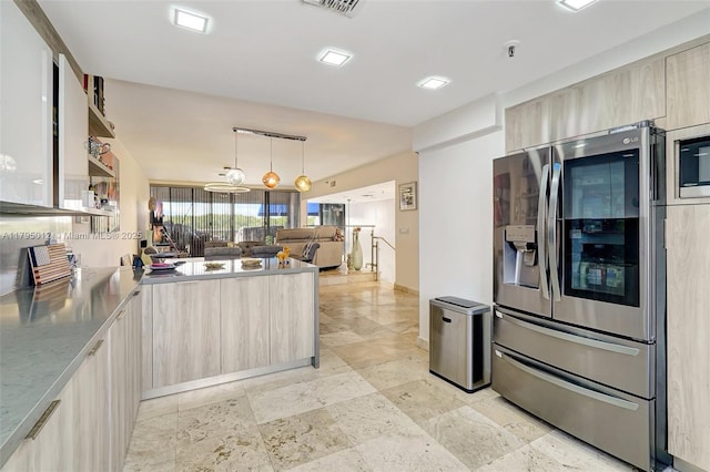 kitchen with pendant lighting, light brown cabinetry, modern cabinets, a peninsula, and stainless steel appliances