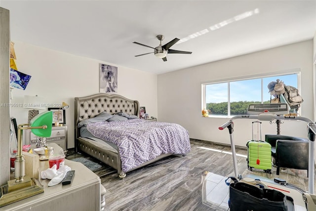 bedroom with baseboards, ceiling fan, and wood finished floors