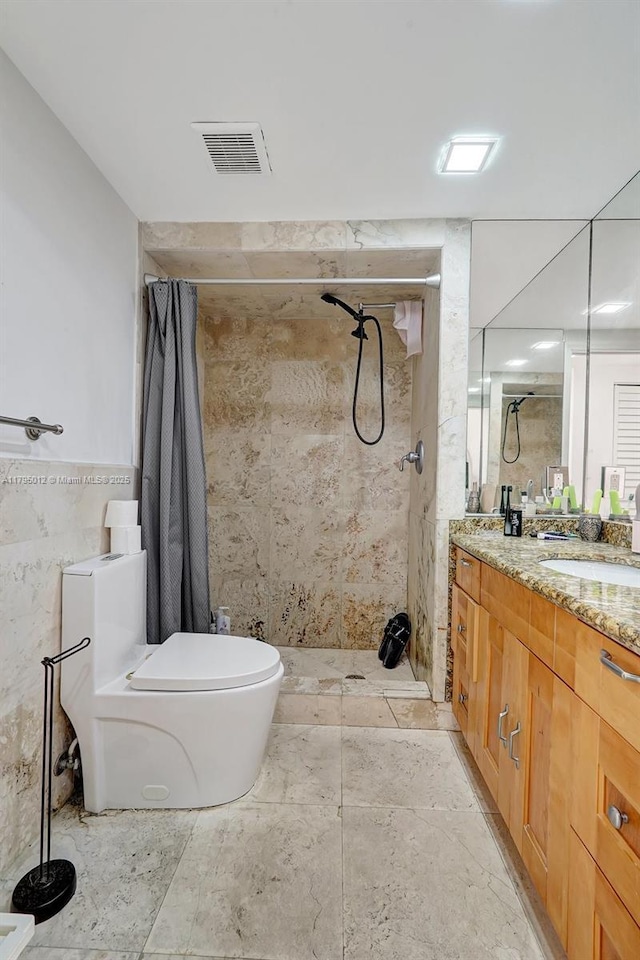 full bathroom with visible vents, vanity, toilet, tile walls, and tiled shower