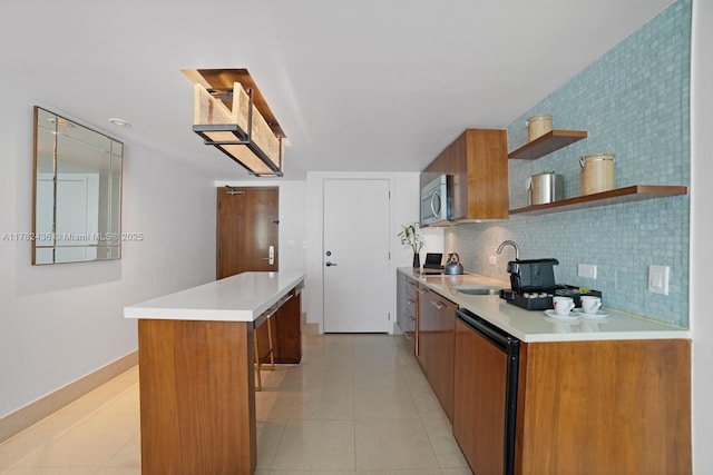6801 Collins Ave Unit 604, Miami Beach, FL 33141 - kitchen featuring brown cabinets, open shelves, a kitchen island, a sink, and dishwasher
