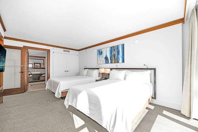 bedroom with visible vents, ornamental molding, a closet, and light colored carpet