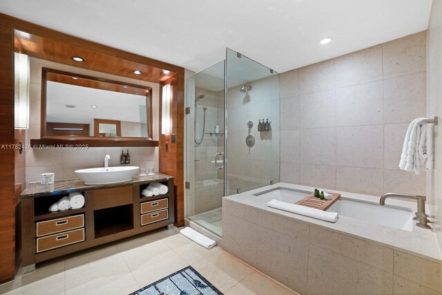 6801 Collins Ave Unit 604, Miami Beach, FL 33141 - full bath featuring tile walls, a shower stall, tile patterned flooring, a bath, and vanity