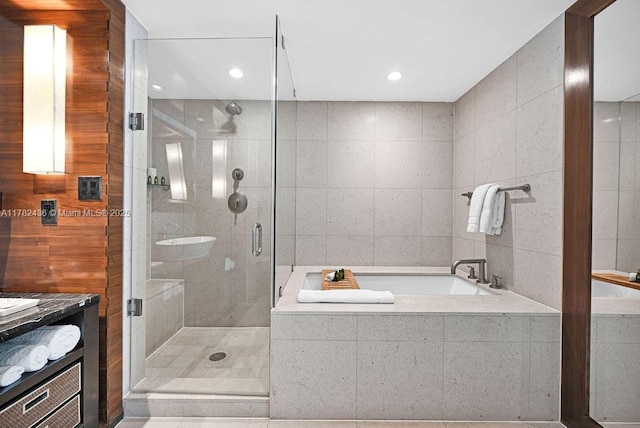 bathroom featuring a garden tub, a stall shower, and vanity