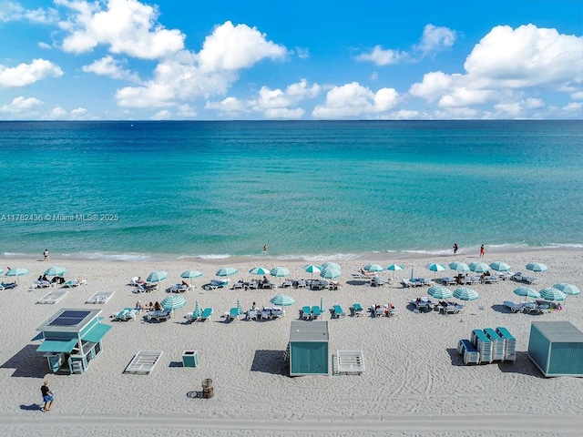 drone / aerial view with a view of the beach and a water view