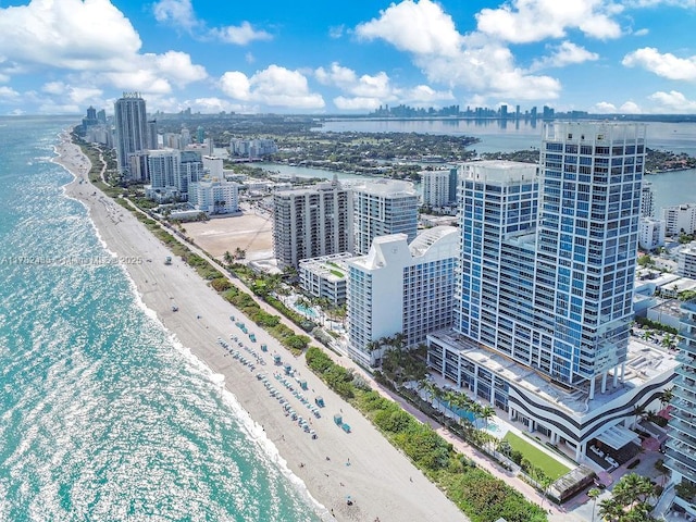 birds eye view of property featuring a water view, a city view, and a view of the beach