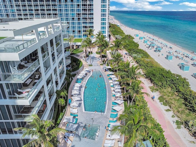bird's eye view featuring a water view and a beach view