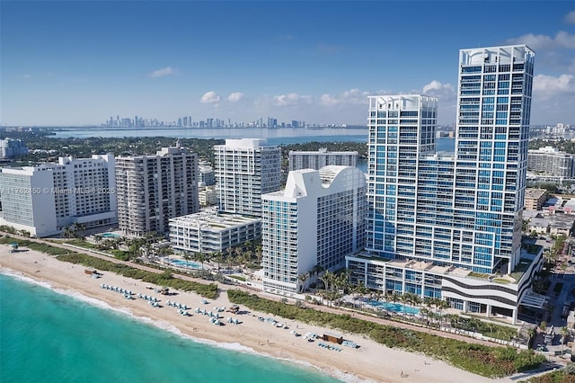 aerial view featuring a view of the beach, a city view, and a water view