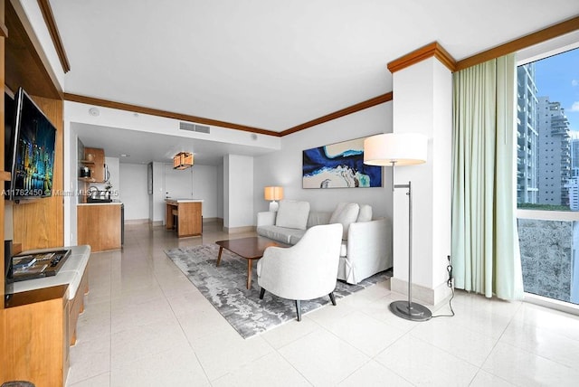 living area featuring crown molding, baseboards, and visible vents