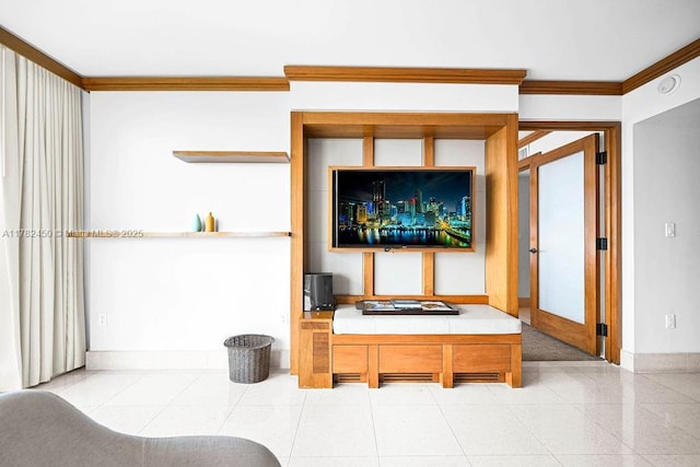 living area featuring crown molding and baseboards