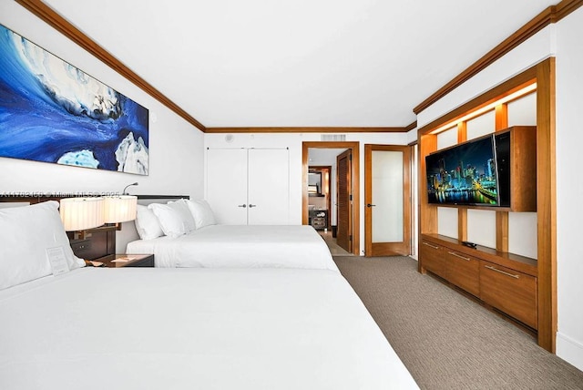 carpeted bedroom with crown molding and visible vents