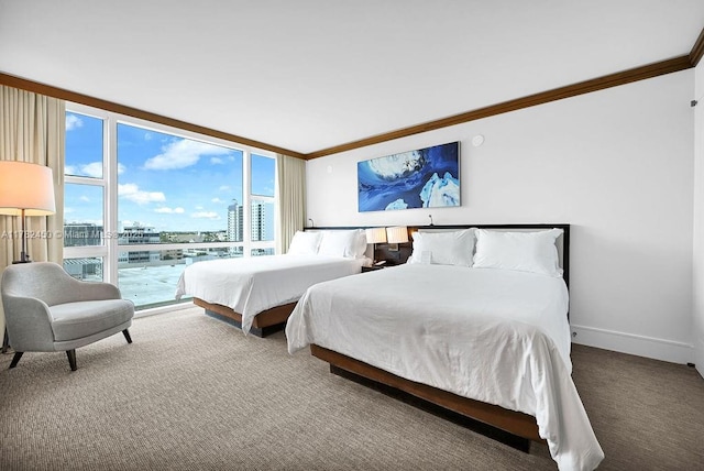 carpeted bedroom with a view of city, ornamental molding, and baseboards