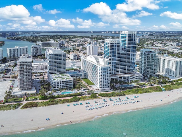 aerial view with a water view, a city view, and a beach view