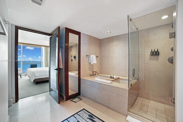 6801 Collins Ave Unit 605, Miami Beach, FL 33141 - ensuite bathroom with a garden tub, a stall shower, tile patterned floors, and recessed lighting