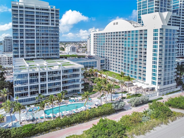 view of property featuring a community pool and a city view