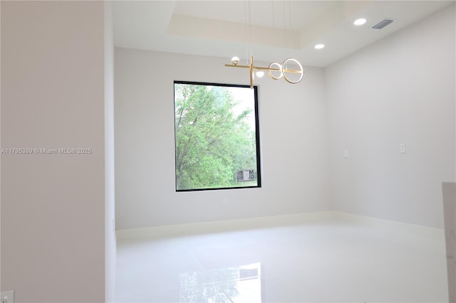 spare room with visible vents, recessed lighting, and a notable chandelier