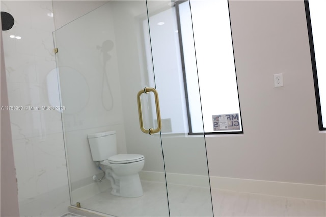full bathroom with baseboards, a marble finish shower, and toilet
