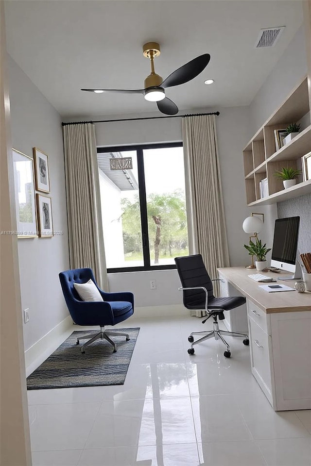 office featuring baseboards, ceiling fan, and light tile patterned floors