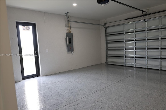 garage with a garage door opener and electric panel