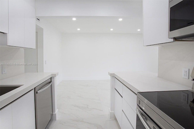 kitchen with modern cabinets, stainless steel appliances, and white cabinets