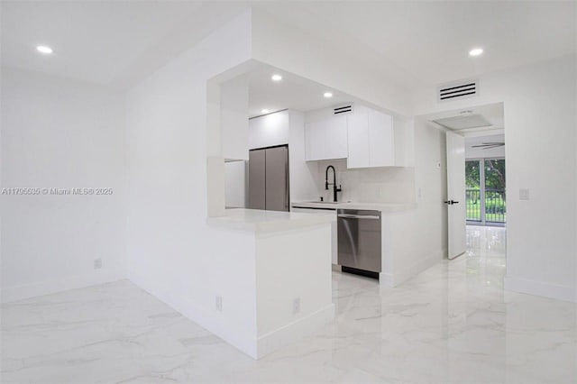 kitchen with white cabinets, light countertops, marble finish floor, stainless steel appliances, and modern cabinets