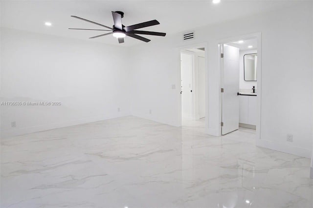 empty room featuring baseboards, marble finish floor, recessed lighting, and visible vents