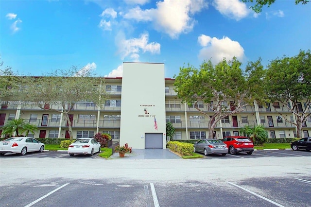 view of building exterior featuring uncovered parking