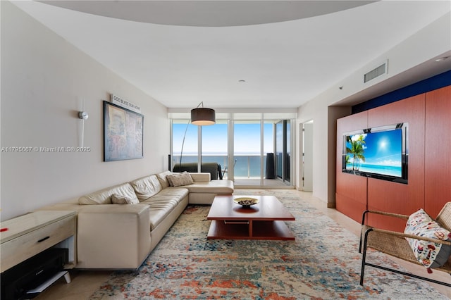 living room featuring expansive windows and visible vents