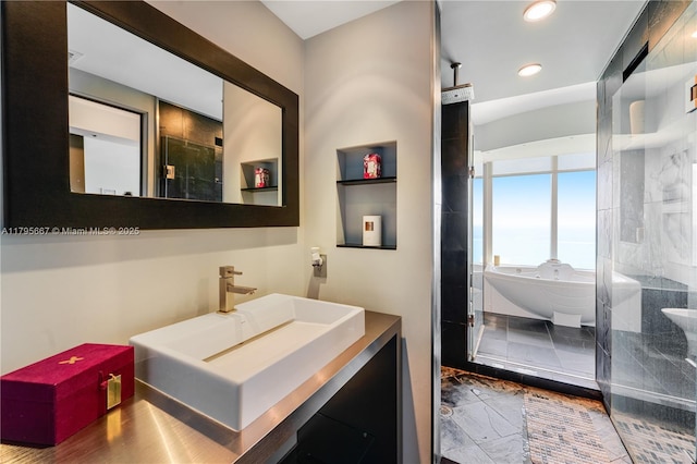 full bathroom with recessed lighting, a freestanding tub, and vanity