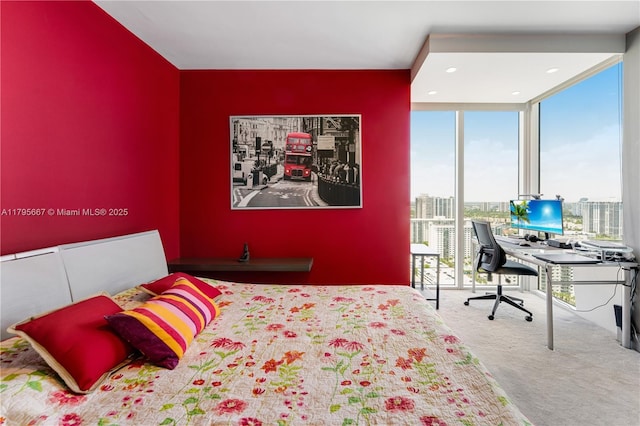 bedroom with expansive windows and carpet floors