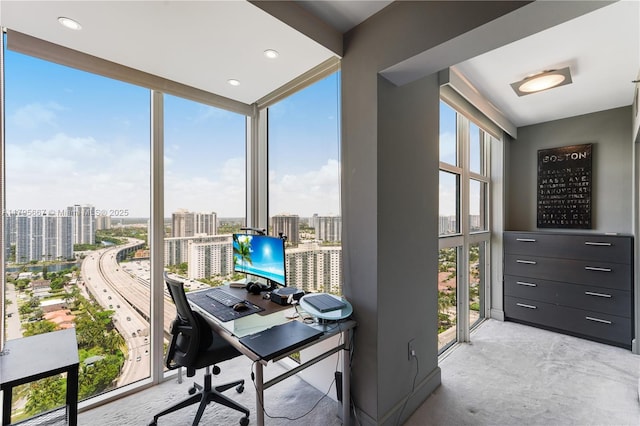 carpeted office space with floor to ceiling windows