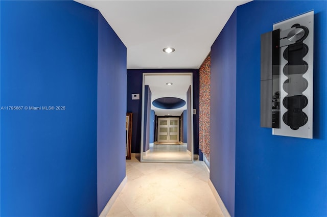 hallway with baseboards and recessed lighting