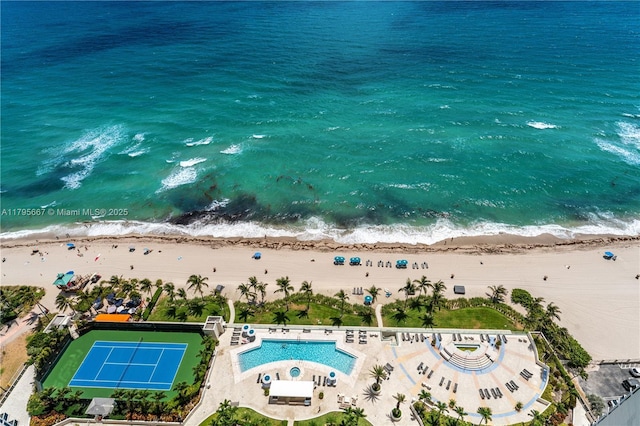 drone / aerial view featuring a water view and a view of the beach