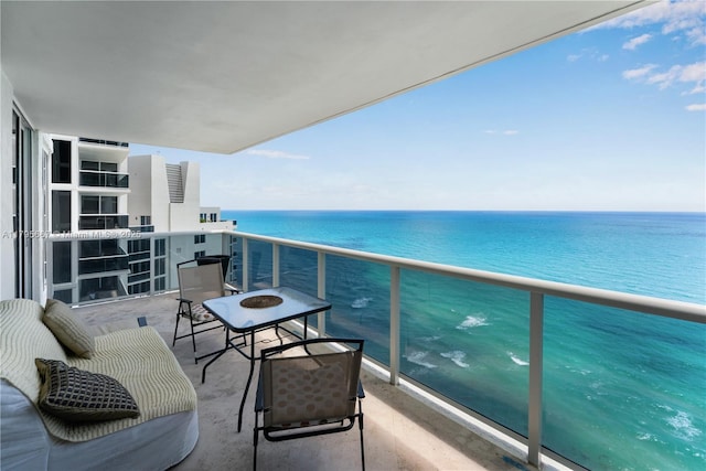 balcony with a water view and a beach view