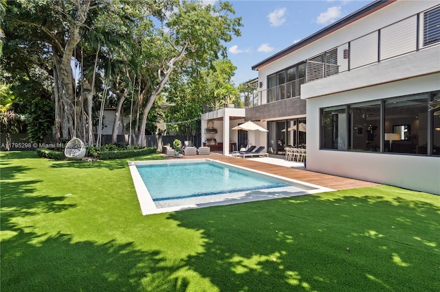 view of pool with a fenced in pool, fence, a lawn, and a patio area