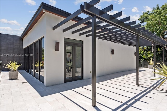 view of patio featuring french doors and a pergola
