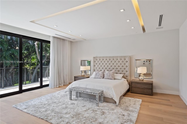 bedroom featuring visible vents, wood finished floors, access to exterior, baseboards, and recessed lighting